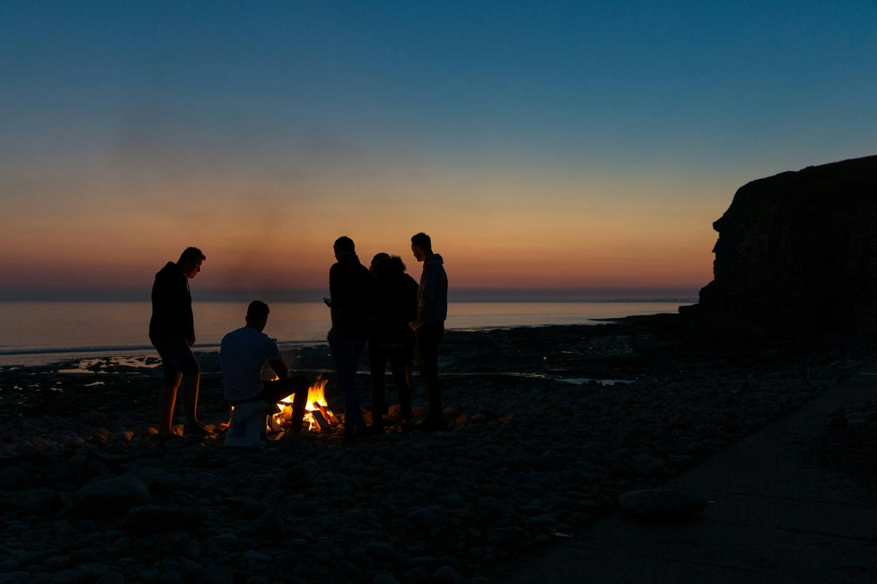 Visitors Enjoy a Fire on The Beach